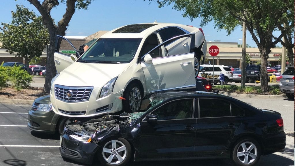 Florida driver crashes on top of two parked cars, no one injured