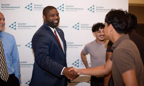Congressman Byron Donalds (FL-19) shaking hands with Elexsi Rodriguez, Graduate while Jan Leon, Graduate and Brian Willard, Education Manager, JA Pre-Apprenticeship Program look on