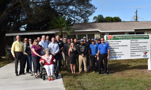 Donors and volunteers celebrate with homeowner Phyllis Puett