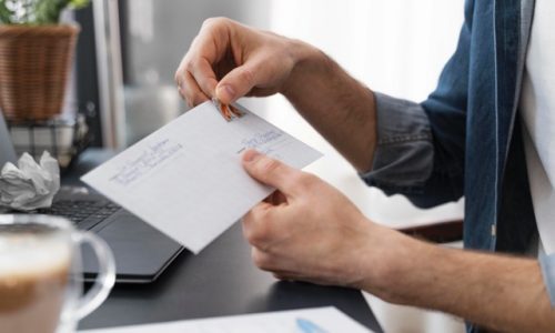 close-up-man-sealing-envelope Medium