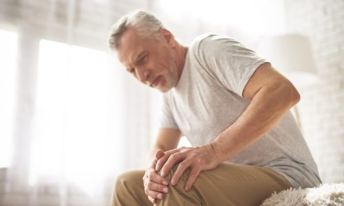 Retired Man Pensioner Suffering Knee Pain at Home.
